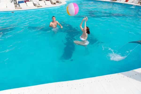 Giovane coppia frolicking in una piscina — Foto Stock