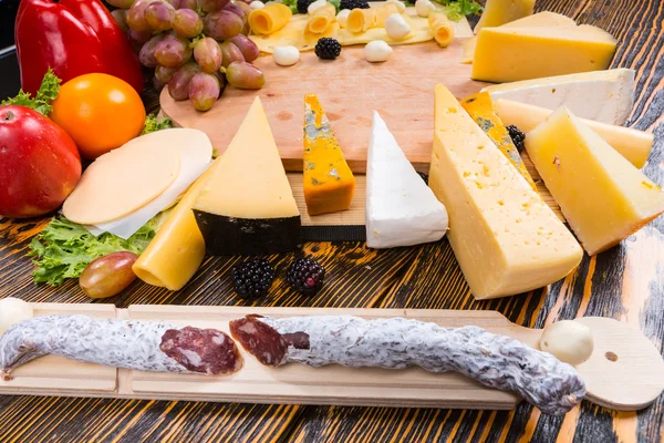 Spicy sausage and a cheese platter on a buffet — Stock Photo, Image