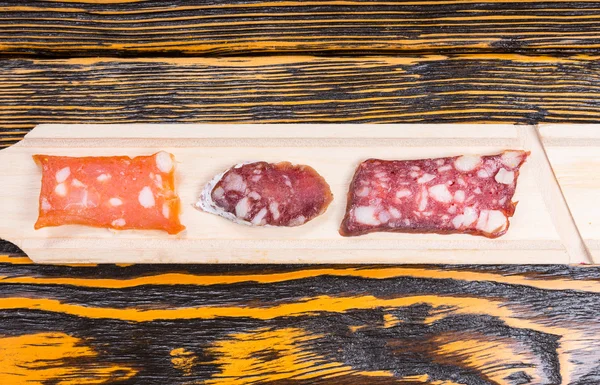 Variety of Sliced Gourmet Meats on Long Wood Board — Stock fotografie