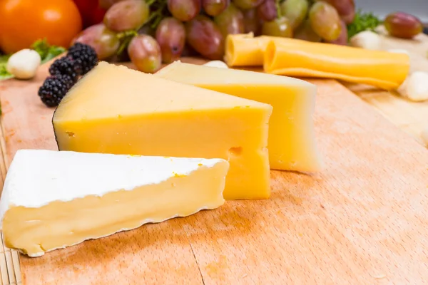 Variety of different cheese wedges on a board