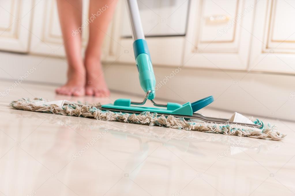 Young Woman Mopping Kitchen Floor