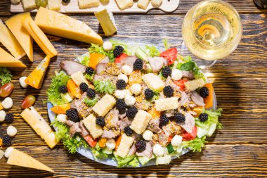 Gourmet Salad and Glass of Wine on Wooden Table