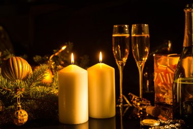 Lit Candles with Festive Glasses of Champagne
