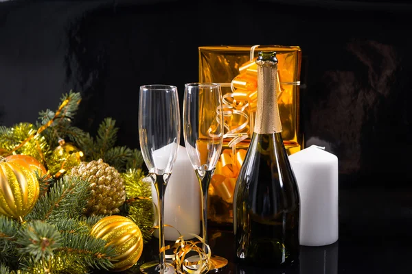Бутылка шампанского и бокалы с рождественскими подарками — стоковое фото