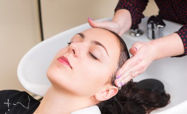 Relaxed Woman Having Hair Washed in Salon clipart