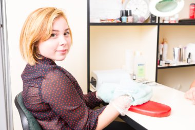 Woman Getting Parrafin Wax Manicure Treatment