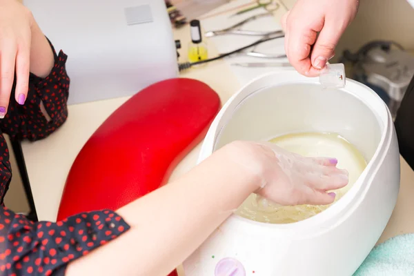 Woman Dipping Hand in Parrafin Wax Spa Treatment — Zdjęcie stockowe