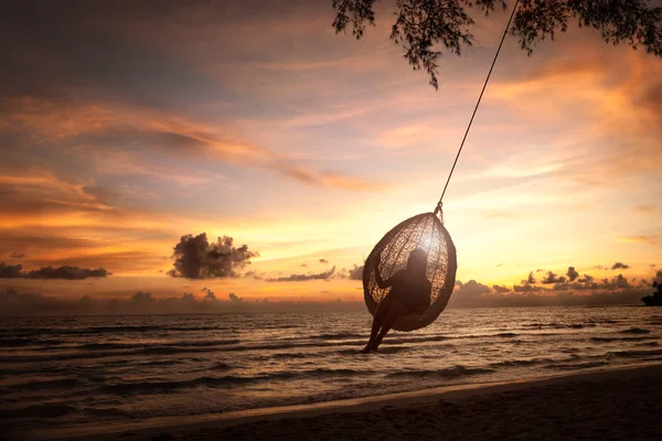 Silhouette woman on a beach swing — Stock Photo, Image