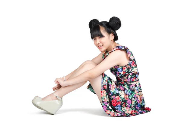 Smiling teenage asian girl sitting on the floor — Stock Photo, Image