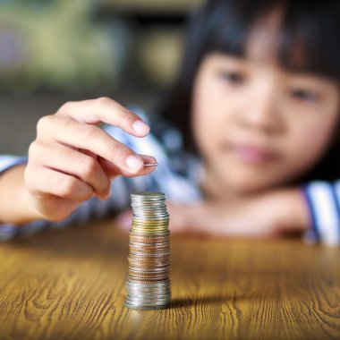 Little girl counts his coins