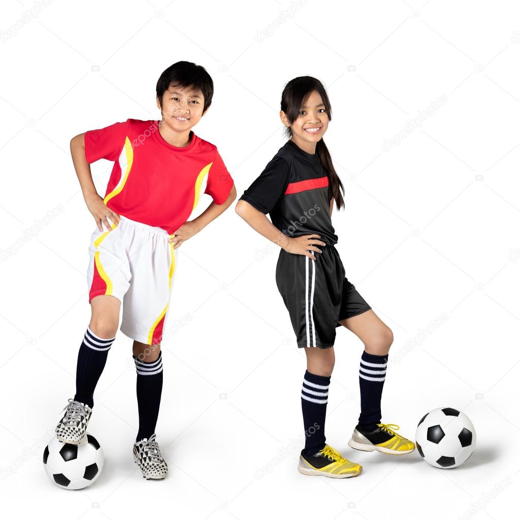 Young asian children playing soccer