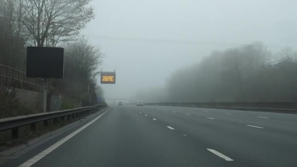 Driving Highway Fog Message Roadside Board Drivers Saying Stay Home — Stock Video