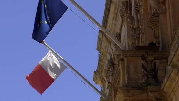 Two Flags Malta European Union Waving Short Poles Old Building — Stock Video