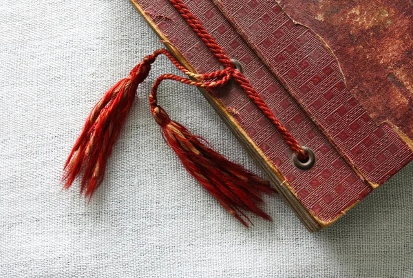 Old red photo album with tassels — Stock Photo, Image