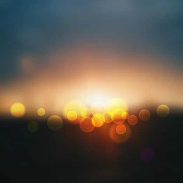 Panoráma města rozmazané. poušť v západu slunce s de zaměřuje světla, abstraktní světlé rozostření pozadí. Abstraktní pozadí vektorové ilustrace — Stockový vektor