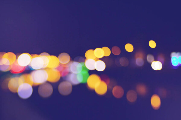 Beautiful bokeh of the night city lights. Blur background of skyscraper buildings. Unfocused old city view, blurred out of focus background. Abstract backdrop for text or advertising.