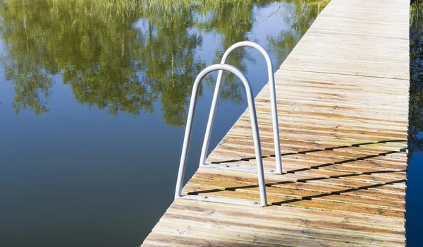 Metal ladder into the pool or lake — Stock Photo, Image