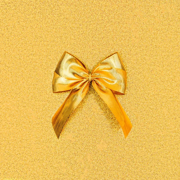 Close Gold Foil Bow Middle Square Shimmering Golden Sequined Backdrop — стоковое фото
