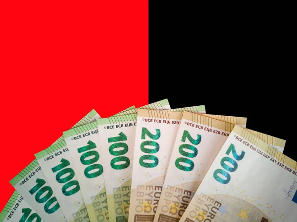 Close up fan of several new euro banknotes 2019 with face value one,two hundred on duo colored red black background.Gambling,choice concept.Bet on black or red.Demonstrating European currency income