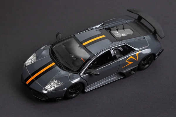 Model of a dark sports car on a dark background.