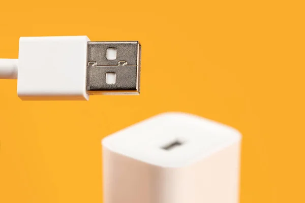 Usb cable with usb connector on yellow background.
