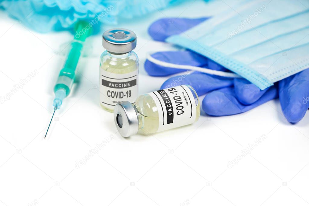 Coronavirus covid-19 vaccine vial. Medical attributes, mask and syringes on a white background.