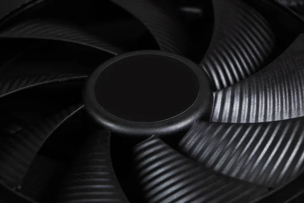 Computer fan on a black background close up.