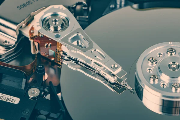 Disassembled hard drive from the computer, hdd with mirror effect. Opened hard drive from the computer hdd with mirror effects. Part of computer pc, laptop