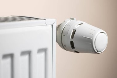 Thermostatic head and radiator valve. Energy saving and save money concept. Reduce consumption of gas or electricity.