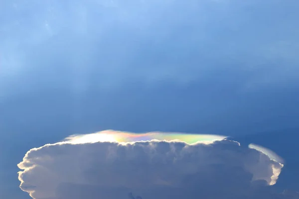 Clouds that form mushroom-like circles and have rainbow-colored lights appearing all around.