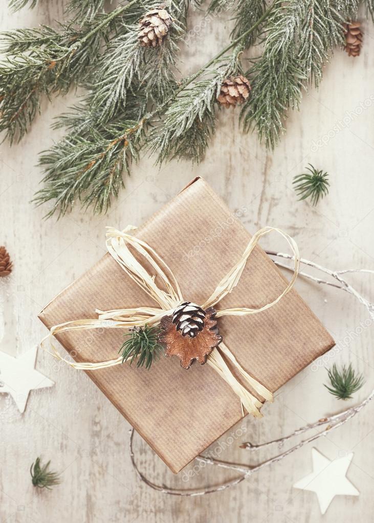 Christmas gift with handmade wrapping Stock Photo by ©Slast 120270492