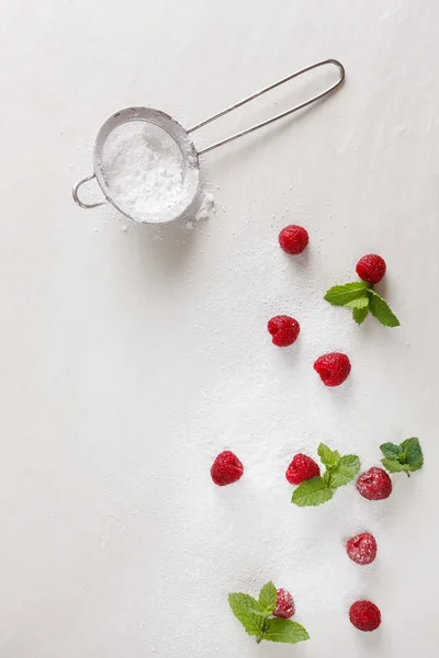 Raspberries in a pile of sugar — Stock Photo, Image