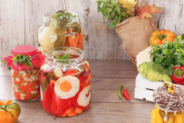 Pickled vegetables in a jar on a garden table