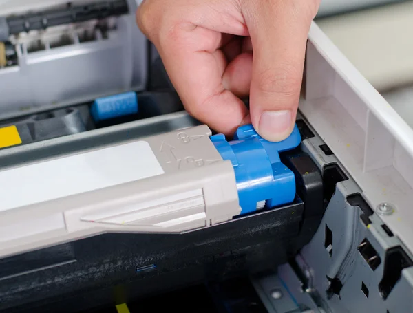 Male hand putting and lock color printer toner — Stock Photo, Image