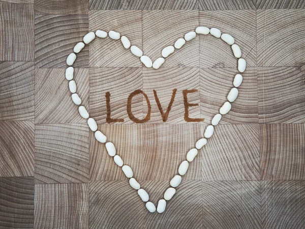 The heart of white stones on the wooden surface — Stock Photo, Image