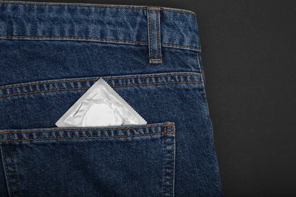Condom in package in jeans. Men found condoms to prevent sexually transmitted infections or AIDS. Prevent HIV disease. Sexually transmitted disease (Mature Content)