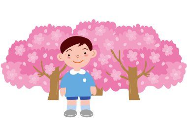 Çiçekli bir kiraz ağacının önünde bir çocuk anaokulu çocuğu.