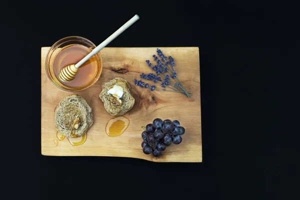 Jar with organic honey, nut, grape, walnut and lavender on wood — Stock Photo, Image