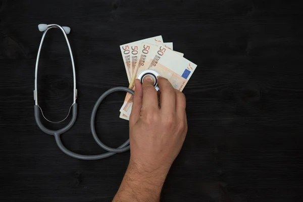 Stethoscope on top of euro banknotes — Stock Photo, Image