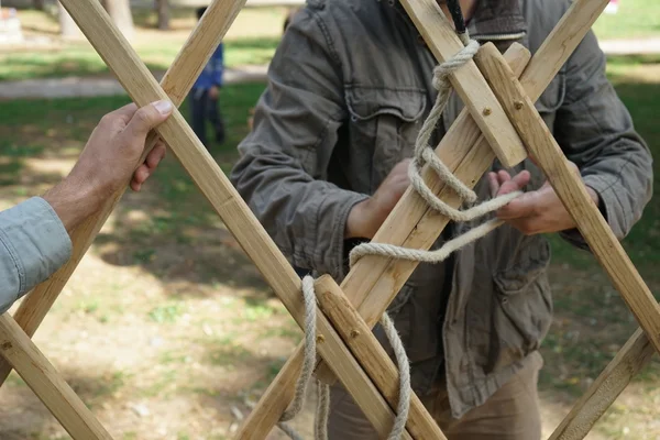 Hands of male builders. Men build Asian yurt frame. — Stock Photo, Image