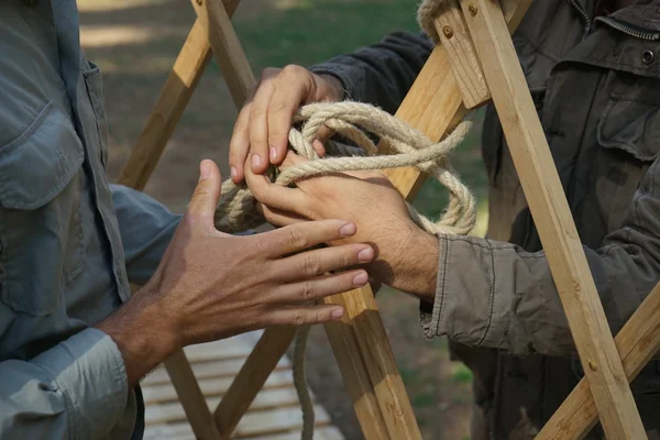 Hands of male builders. Men build Asian yurt frame. — Stock Photo, Image