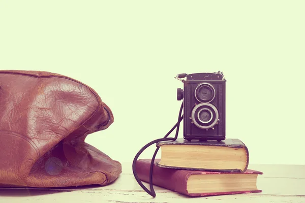 Vintage suitcases with books and camera — Stock Photo, Image