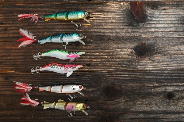 Balık tutma yemler üzerinde ahşap arka plan izole — Stok fotoğraf