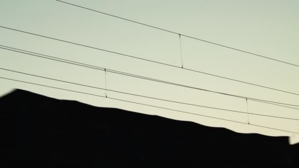 Güterzugfahrten auf der Eisenbahn bei Sonnenuntergang in Silhouette. Eisenbahnfracht. Export von Waren. — Stockvideo