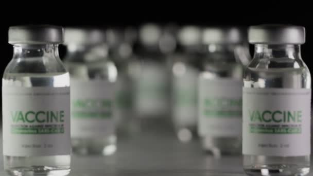 Vials of vaccine for COVID-19 coronavirus cure are in research lab before injection. Vaccination, clinical trial during pandemic. Flasks, bottles. Wide macro slider dolly in shot. SARS-Cov-2. Nobody — Stock Video