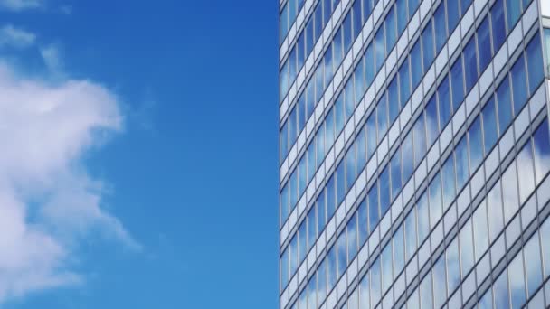 Skyscraper facade. Offices. Blue sky, clouds. Reflection. Business center. Corporate building, glass windows. Mirror. Commercial financial success. Administrative, government construction. Copy space — Stock Video