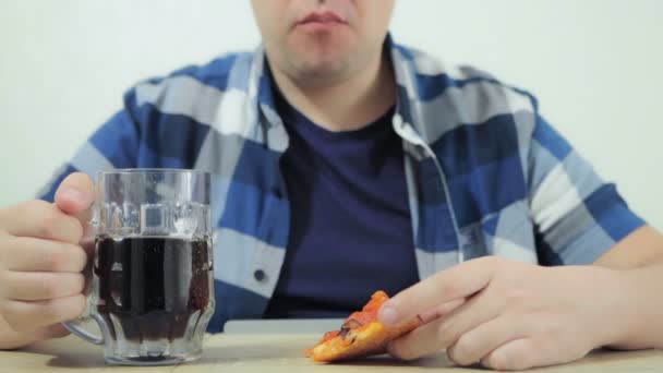 Man is eating pizza, drinking carbonated beverage or dark beer, watching sports channel during soccer football world championship cup on TV. Harmful lifestyle. Depression, loneliness. Weekend. Movie — Stock Video