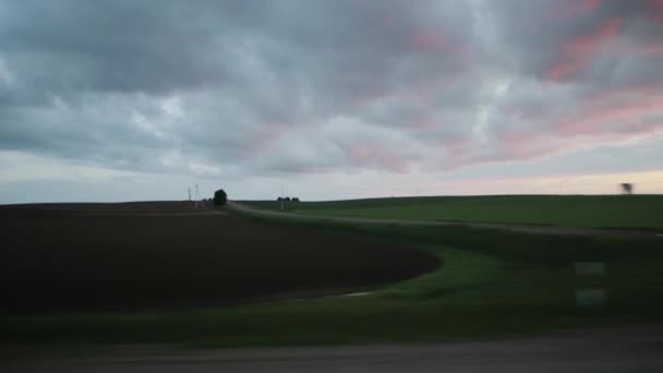 View from the car window on a trip. Evening beautiful sky and fields with grass. Copy space for text, landscape — Stock Video