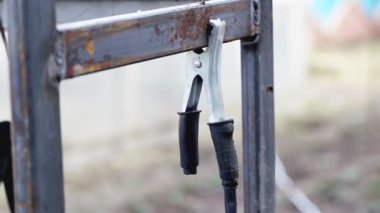 Earth clamp on a metal structure during welding, close-up. Protective
