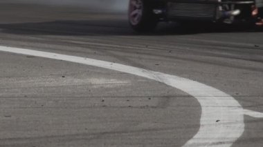 2 cars drift on a sharp turn of the asphalt road during the show. Tire burnout. Racing competitions in slow motion. Motorsport championship. High fast speed. Professional extreme drive